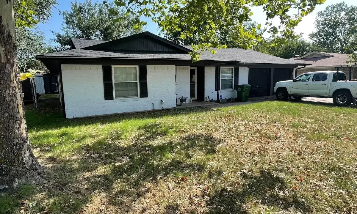 Professional roofing crew working on a residential roof in Lufkin